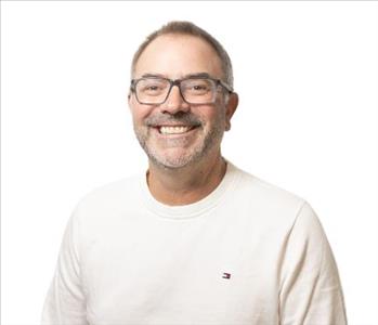 A SERVPRO® employee in front of a white background