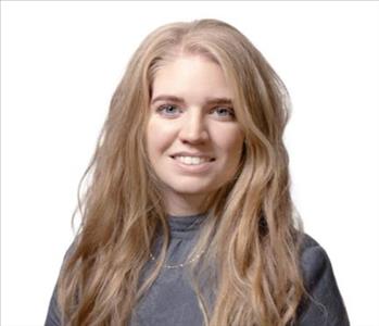 A SERVPRO® employee in front of a white background