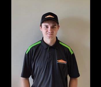 SERVPRO® employee in front of grey background