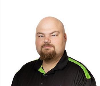 A SERVPRO® employee in front of a white background