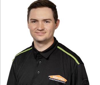 A SERVPRO® employee in front of a white background